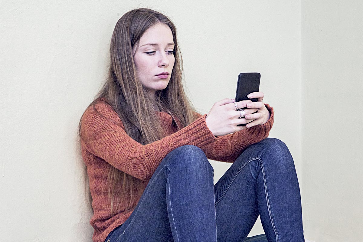young woman trying to make a call at intervention center in california